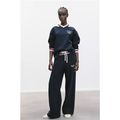 TROUSERS WITH EMBROIDERED SLOGAN