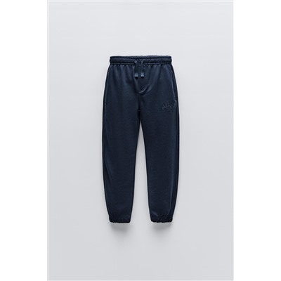 TROUSERS WITH EMBROIDERED SLOGAN
