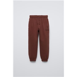 TROUSERS WITH EMBROIDERED SLOGAN
