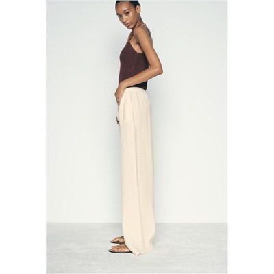 CREASED-EFFECT WIDE-LEG TROUSERS