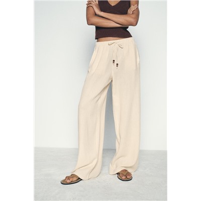 CREASED-EFFECT WIDE-LEG TROUSERS