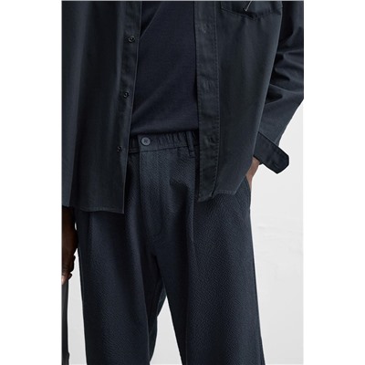 TEXTURED PLEATED TROUSERS