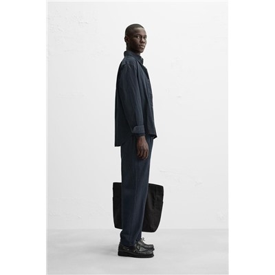 TEXTURED PLEATED TROUSERS