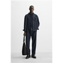 TEXTURED PLEATED TROUSERS