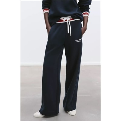 TROUSERS WITH EMBROIDERED SLOGAN
