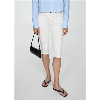 Jeans slim capri costuras decorativas