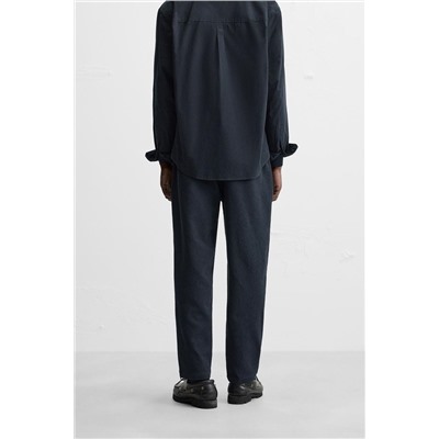 TEXTURED PLEATED TROUSERS