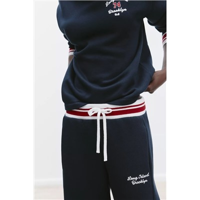 TROUSERS WITH EMBROIDERED SLOGAN