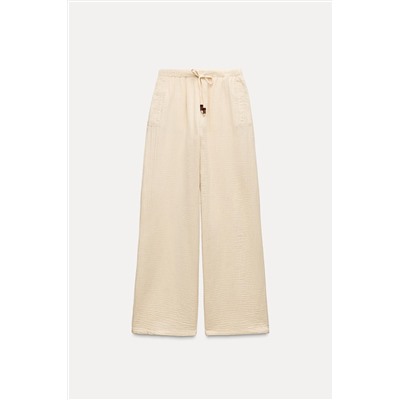 CREASED-EFFECT WIDE-LEG TROUSERS