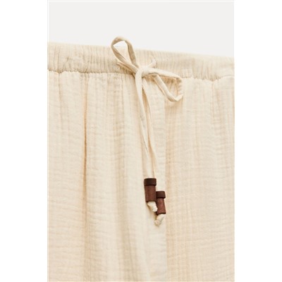 CREASED-EFFECT WIDE-LEG TROUSERS