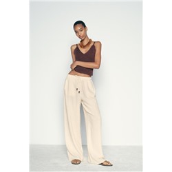 CREASED-EFFECT WIDE-LEG TROUSERS