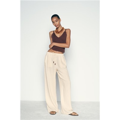 CREASED-EFFECT WIDE-LEG TROUSERS