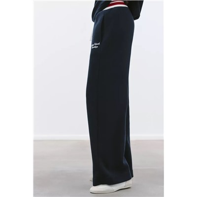 TROUSERS WITH EMBROIDERED SLOGAN
