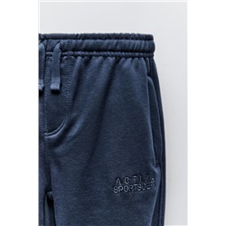TROUSERS WITH EMBROIDERED SLOGAN