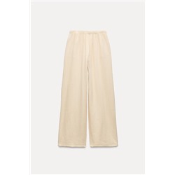 CREASED-EFFECT WIDE-LEG TROUSERS
