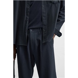 TEXTURED PLEATED TROUSERS