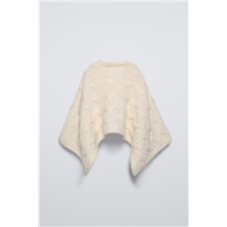 CABLE-KNIT CAPE WITH FLOWER