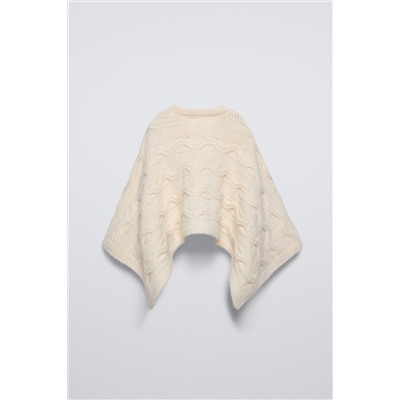 CABLE-KNIT CAPE WITH FLOWER