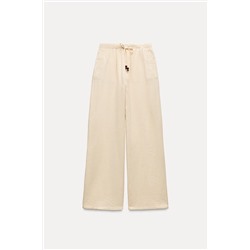 CREASED-EFFECT WIDE-LEG TROUSERS